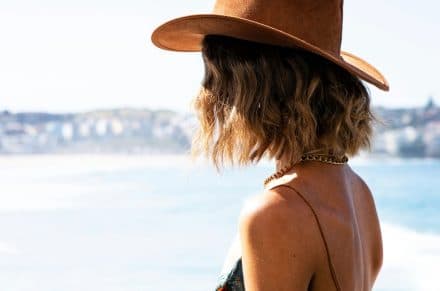 A woman wearing a hat looking at a scenery