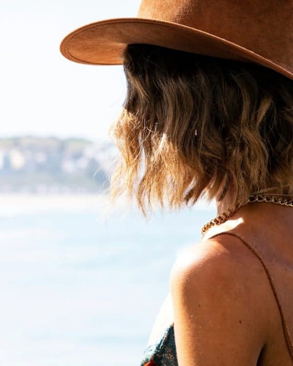 A woman wearing a hat looking at a scenery