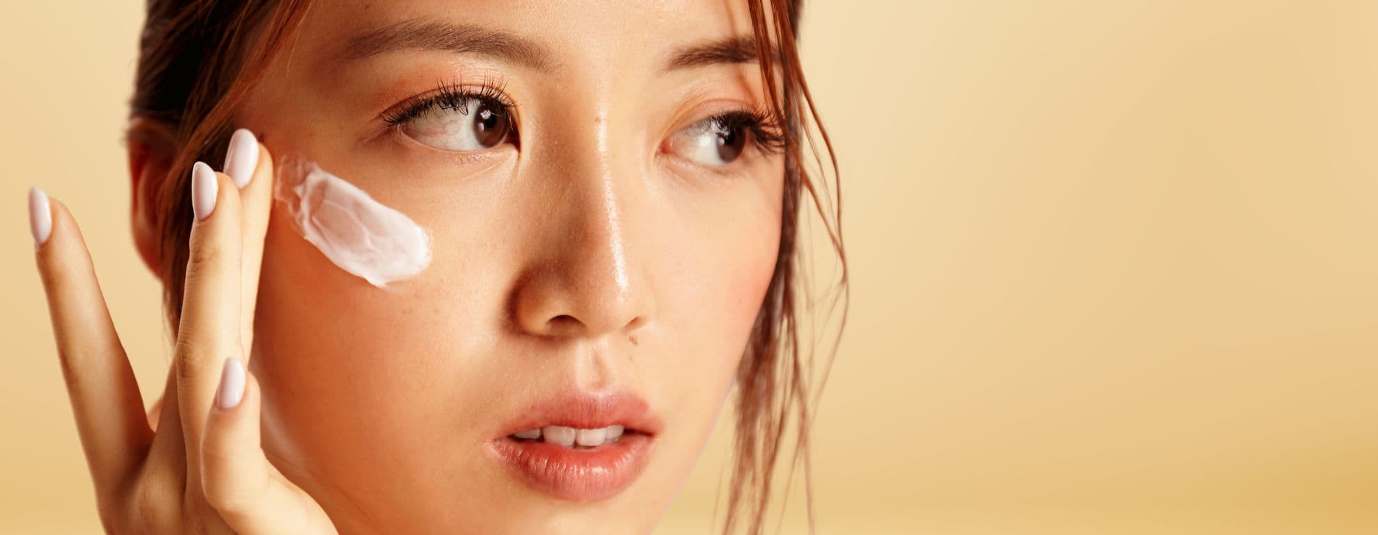 asian girl applied cream on her face