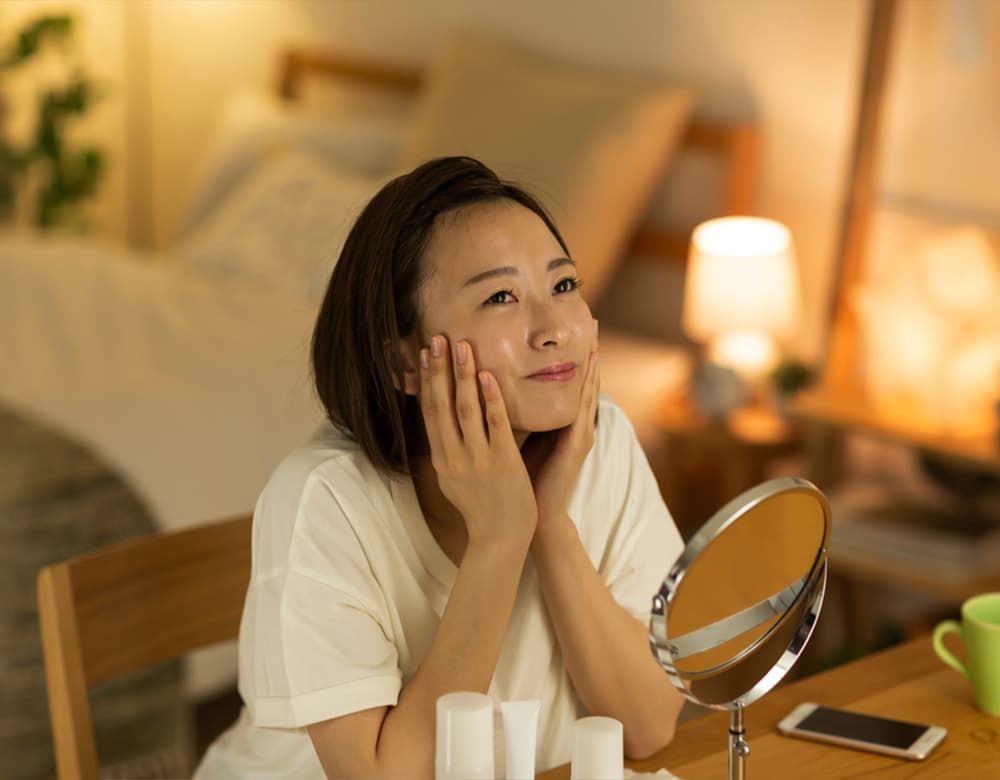 asian woman touching her face