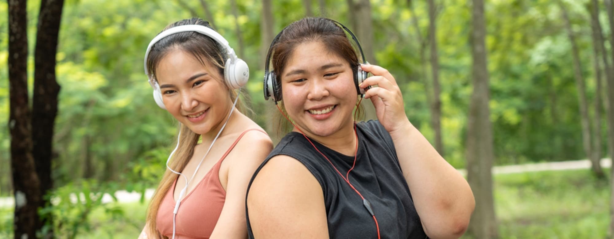 2 asian women having headphones on