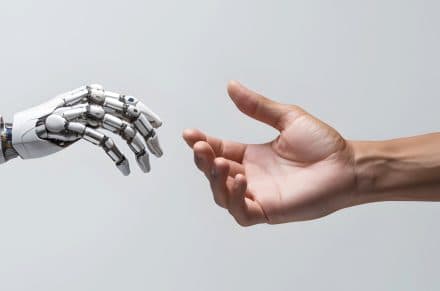 Robot hand reaching out to human hand